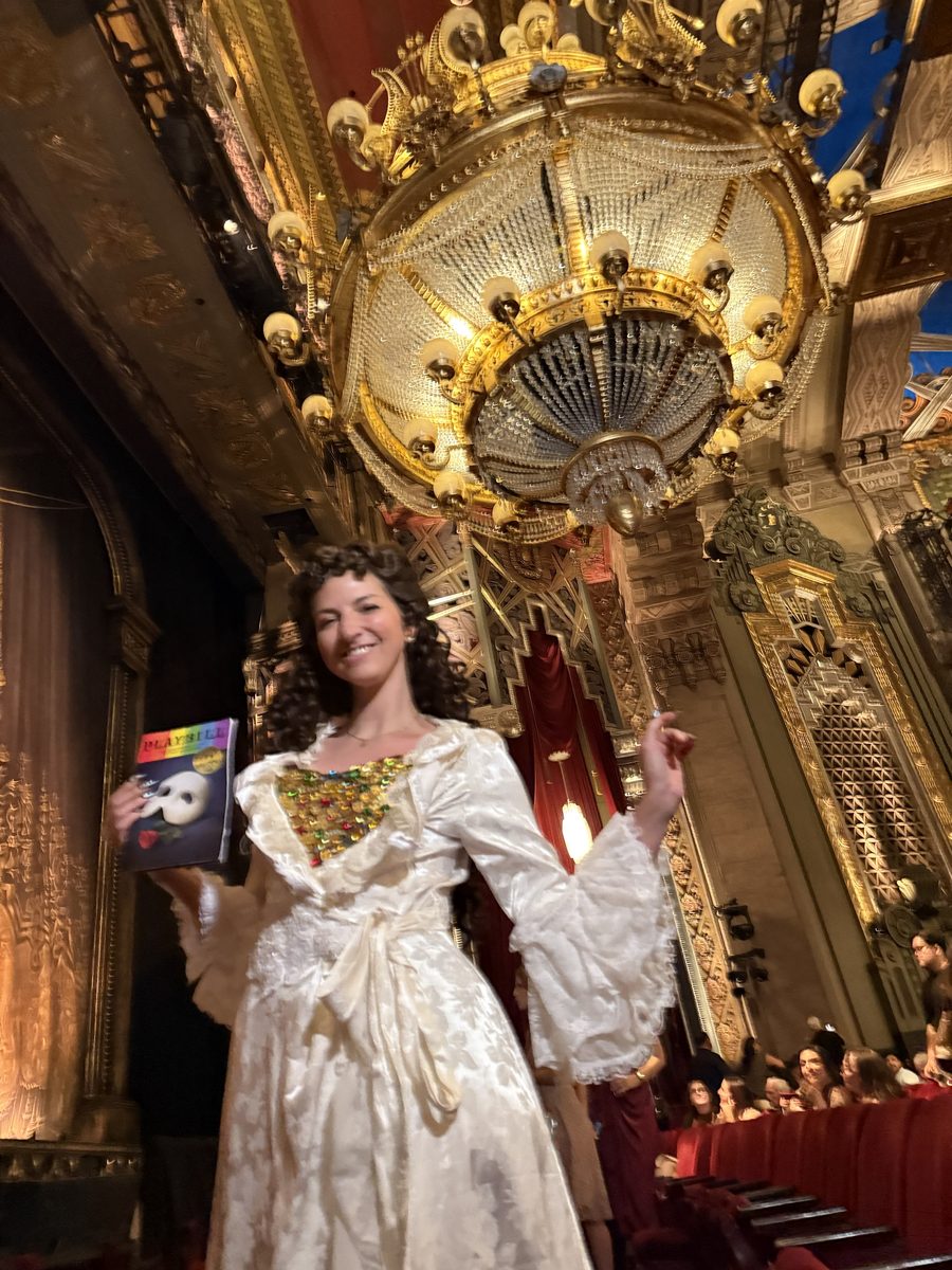 Andrea in a Christine Daae dressing gown cosplay inside a theater