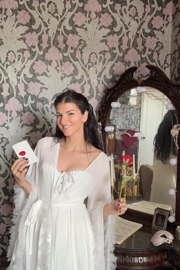 Andrea in a white dressing gown look for Masquerade NYC