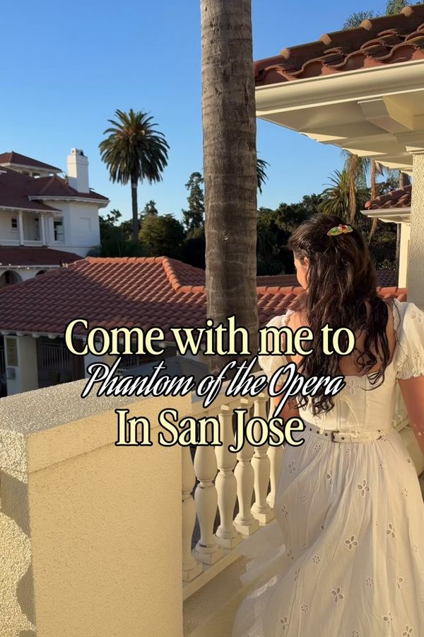 Andrea in a white LaceMade corset dress on a balcony in San Jose