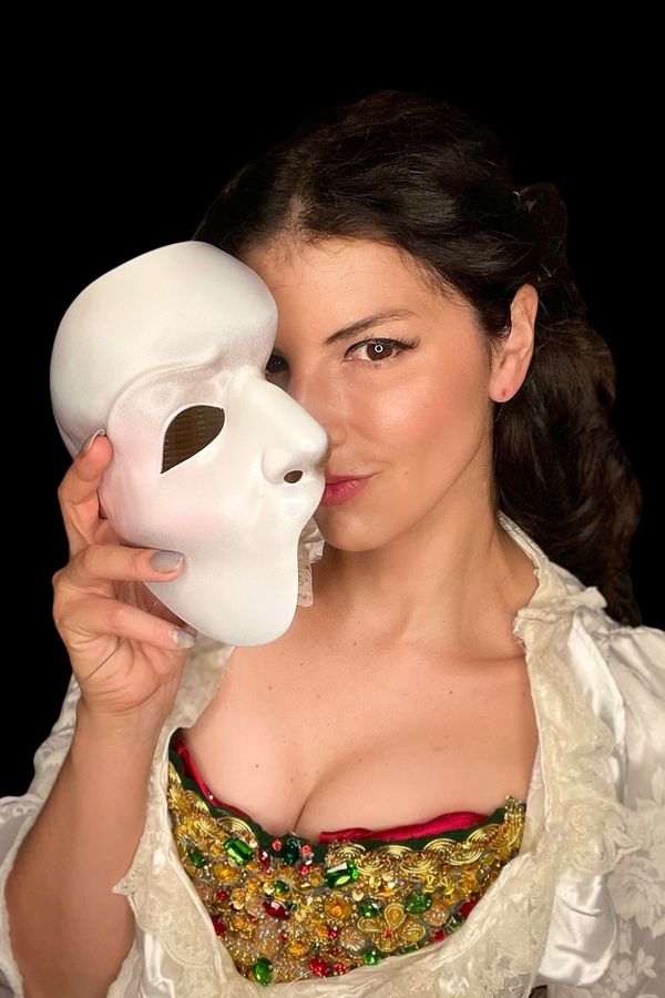 Andrea holding the Lair Sculptures replica of the final Broadway Phantom mask, wearing the Hannibal bodice