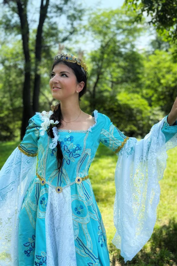 Andrea as Christine as Marguerite in a blue gown and a crown made from Christmas ornaments