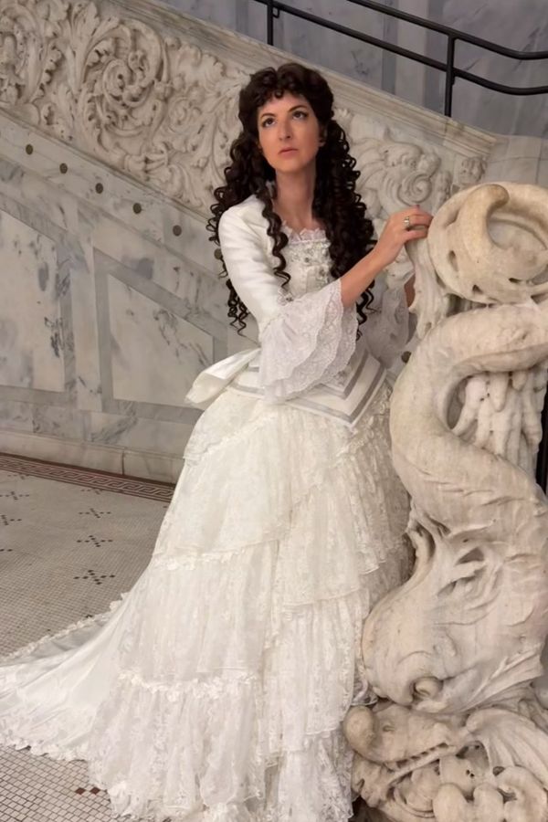 Andrea as Christine Daae in the white Final Lair wedding dress on a marble staircase