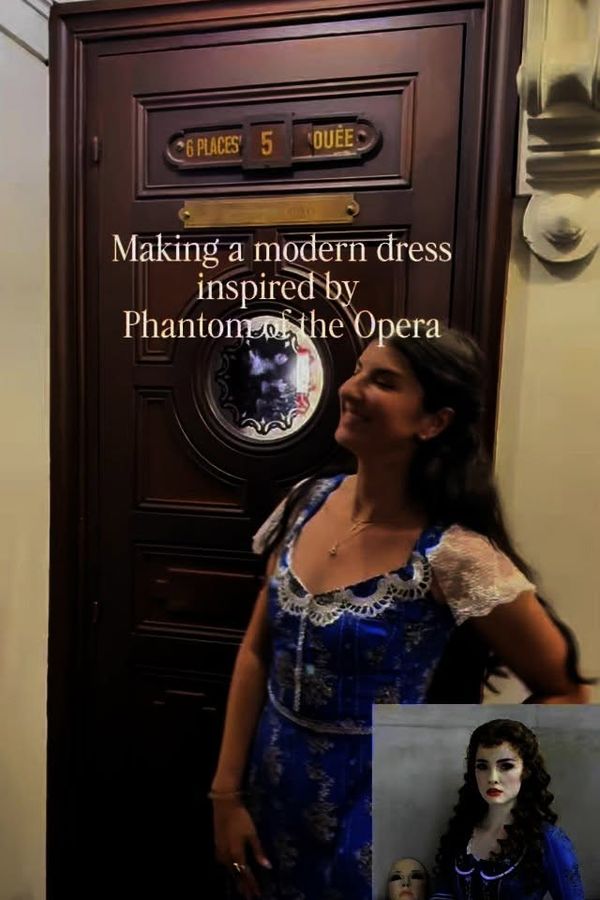 Andrea in the blue Wishing-inspired dress she made, beside a Box Five door